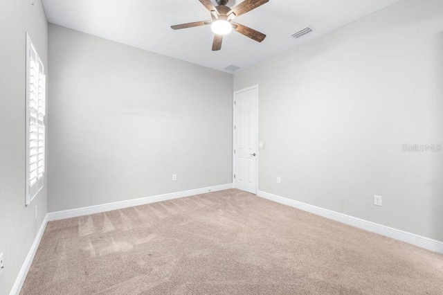 21675 Amelia Rose Way, Land O Lakes, FL 34637 - empty room featuring ceiling fan, light colored carpet, and healthy amount of natural light