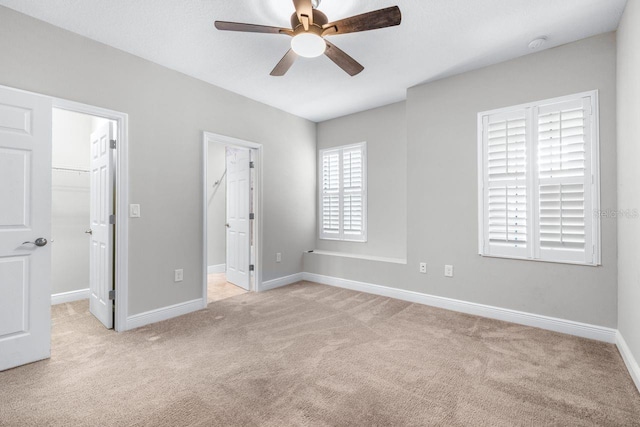 21675 Amelia Rose Way, Land O Lakes, FL 34637 - unfurnished bedroom with carpet, a spacious closet, ceiling fan, and a closet