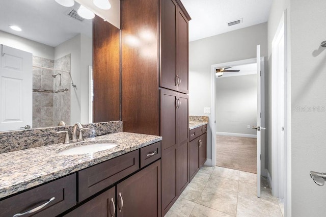 21675 Amelia Rose Way, Land O Lakes, FL 34637 - bathroom featuring a tile shower, ceiling fan, vanity, and tile patterned flooring