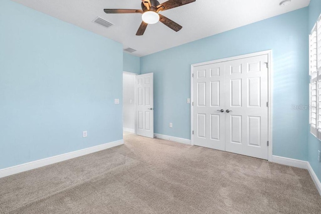 21675 Amelia Rose Way, Land O Lakes, FL 34637 - unfurnished bedroom with carpet flooring, a closet, and ceiling fan