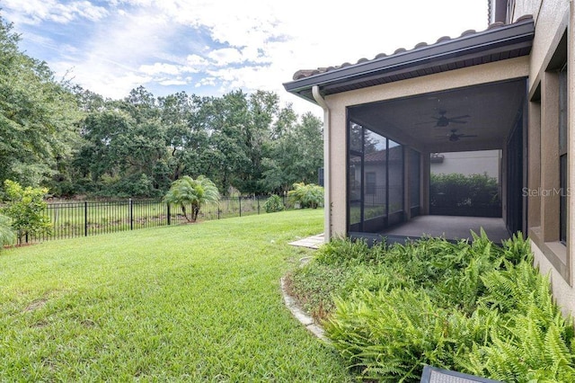 21675 Amelia Rose Way, Land O Lakes, FL 34637 - fenced backyard with ceiling fan, a sunroom, and view of wooded area
