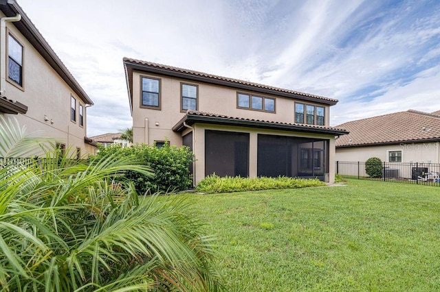 21675 Amelia Rose Way, Land O Lakes, FL 34637 - rear view of house with stucco siding, a sunroom, and a tile roof