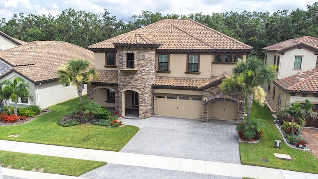 21675 Amelia Rose Way, Land O Lakes, FL 34637 - mediterranean / spanish-style house with a tile roof, stucco siding, decorative driveway, and stone siding