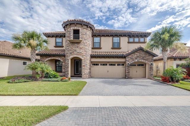 21675 Amelia Rose Way, Land O Lakes, FL 34637 - mediterranean / spanish home with decorative driveway, stucco siding, a tile roof, a front yard, and an attached garage