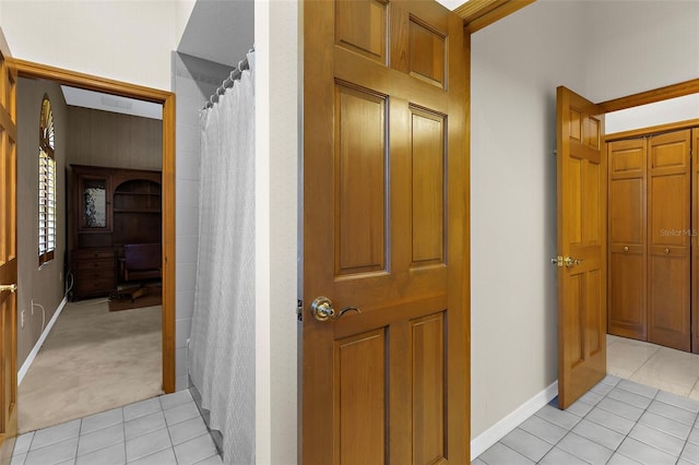 3772 Woodridge Pl, Palm Harbor, FL 34684 - hallway with light tile patterned floors and baseboards