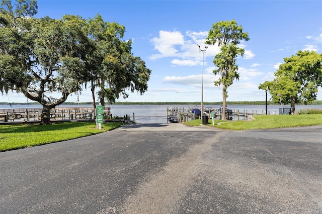 3772 Woodridge Pl, Palm Harbor, FL 34684 - view of asphalt road featuring a water view and street lighting