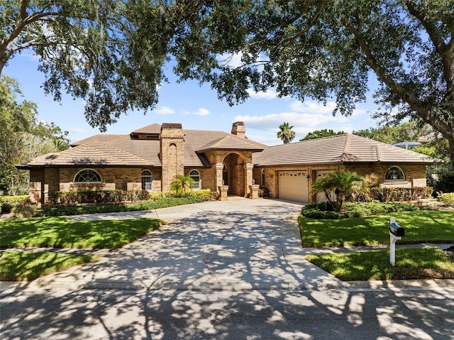 3772 Woodridge Pl, Palm Harbor, FL 34684 - view of front of property featuring a chimney, a tile roof, an attached garage, and concrete driveway