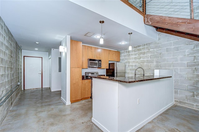 2001 E 2nd Ave Unit 12, Tampa, FL 33605 - kitchen featuring stainless steel appliances, concrete flooring, dark stone counters, pendant lighting, and a peninsula