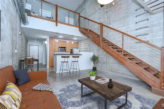 2001 E 2nd Ave Unit 12, Tampa, FL 33605 - living area featuring concrete floors and a high ceiling