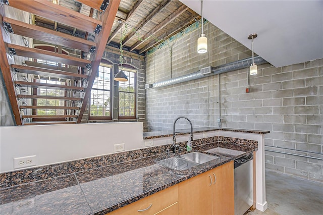 2001 E 2nd Ave Unit 12, Tampa, FL 33605 - kitchen with dishwasher, concrete floors, pendant lighting, and concrete block wall