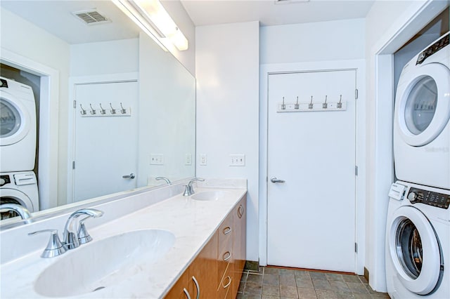 2001 E 2nd Ave Unit 12, Tampa, FL 33605 - laundry room with stacked washer and clothes dryer and stone finish flooring