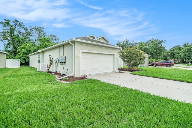 247 Winthrop Dr, Spring Hill, FL 34609 - view of home's exterior with stucco siding, concrete driveway, a lawn, and an attached garage