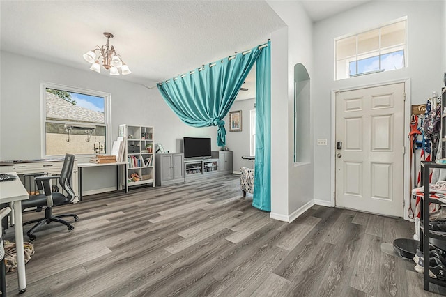 247 Winthrop Dr, Spring Hill, FL 34609 - foyer entrance featuring a chandelier, wood finished floors, and arched walkways