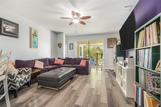 247 Winthrop Dr, Spring Hill, FL 34609 - living room with wood finished floors, a ceiling fan, and a textured ceiling