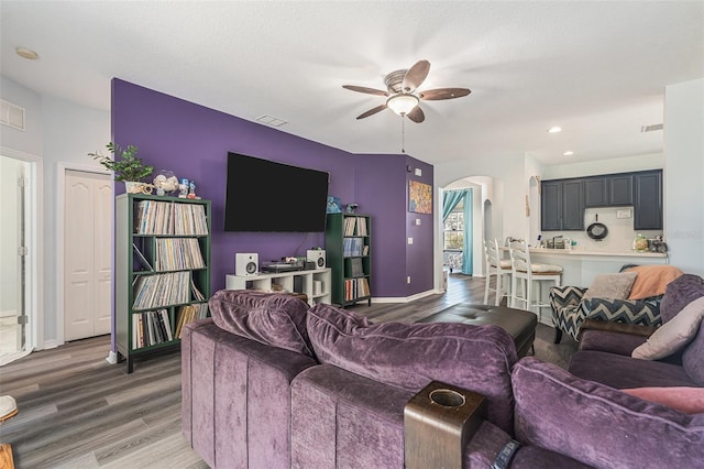 247 Winthrop Dr, Spring Hill, FL 34609 - living room with arched walkways, ceiling fan, wood finished floors, and recessed lighting