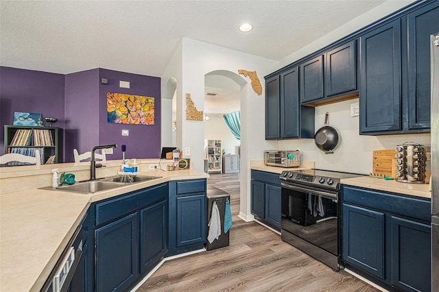 247 Winthrop Dr, Spring Hill, FL 34609 - kitchen featuring electric stove, arched walkways, blue cabinetry, light wood-style floors, and light countertops