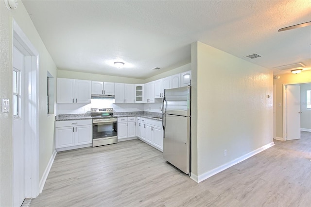 475 W Ethelene St, Bartow, FL 33830 - kitchen with stainless steel appliances, white cabinetry, light wood-style floors, under cabinet range hood, and glass insert cabinets