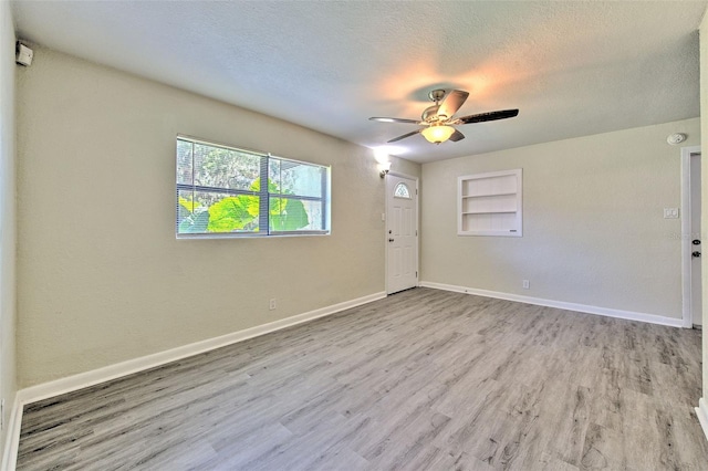 475 W Ethelene St, Bartow, FL 33830 - unfurnished room featuring ceiling fan, wood finished floors, built in features, and a textured ceiling