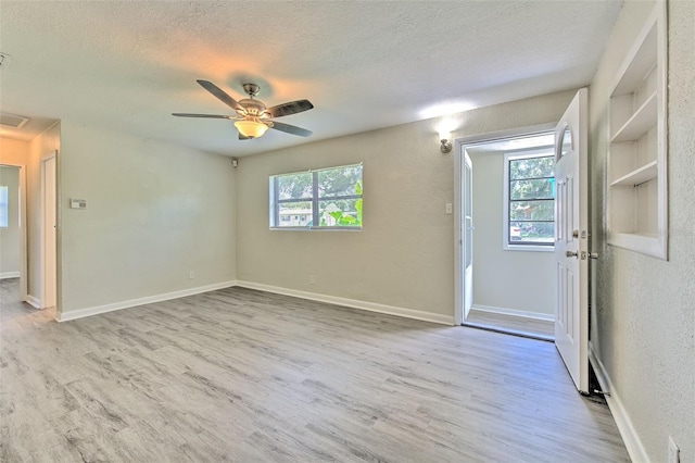 475 W Ethelene St, Bartow, FL 33830 - spare room featuring a textured ceiling, wood finished floors, plenty of natural light, a ceiling fan, and a textured wall