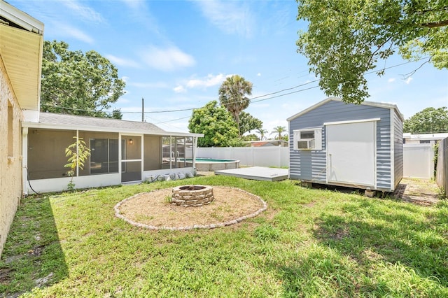 6012 Flora Ter, Apollo Beach, FL 33572 - fenced backyard with a sunroom, a fire pit, a storage shed, and cooling unit