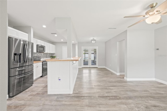 6012 Flora Ter, Apollo Beach, FL 33572 - kitchen featuring appliances with stainless steel finishes, butcher block countertops, light wood-type flooring, tasteful backsplash, and recessed lighting