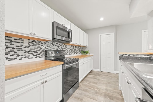 6012 Flora Ter, Apollo Beach, FL 33572 - kitchen featuring appliances with stainless steel finishes, backsplash, white cabinetry, light wood-type flooring, and recessed lighting