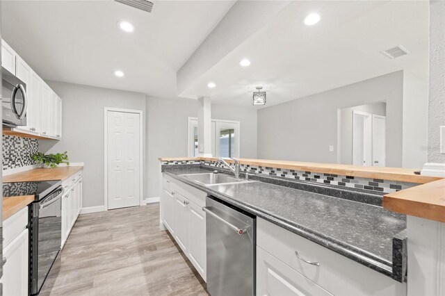 6012 Flora Ter, Apollo Beach, FL 33572 - kitchen with appliances with stainless steel finishes, tasteful backsplash, recessed lighting, butcher block counters, and white cabinets