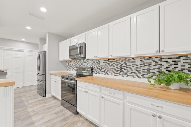 6012 Flora Ter, Apollo Beach, FL 33572 - kitchen with stainless steel appliances, white cabinets, backsplash, recessed lighting, and light wood-type flooring