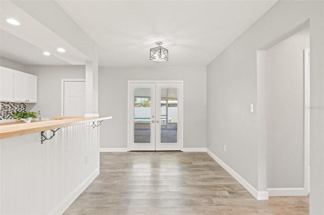6012 Flora Ter, Apollo Beach, FL 33572 - unfurnished dining area with recessed lighting, light wood-type flooring, and french doors