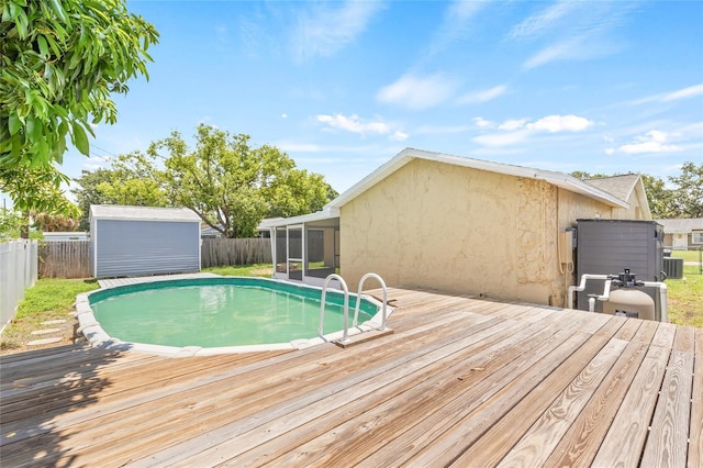6012 Flora Ter, Apollo Beach, FL 33572 - view of pool with a sunroom, a wooden deck, and a fenced backyard