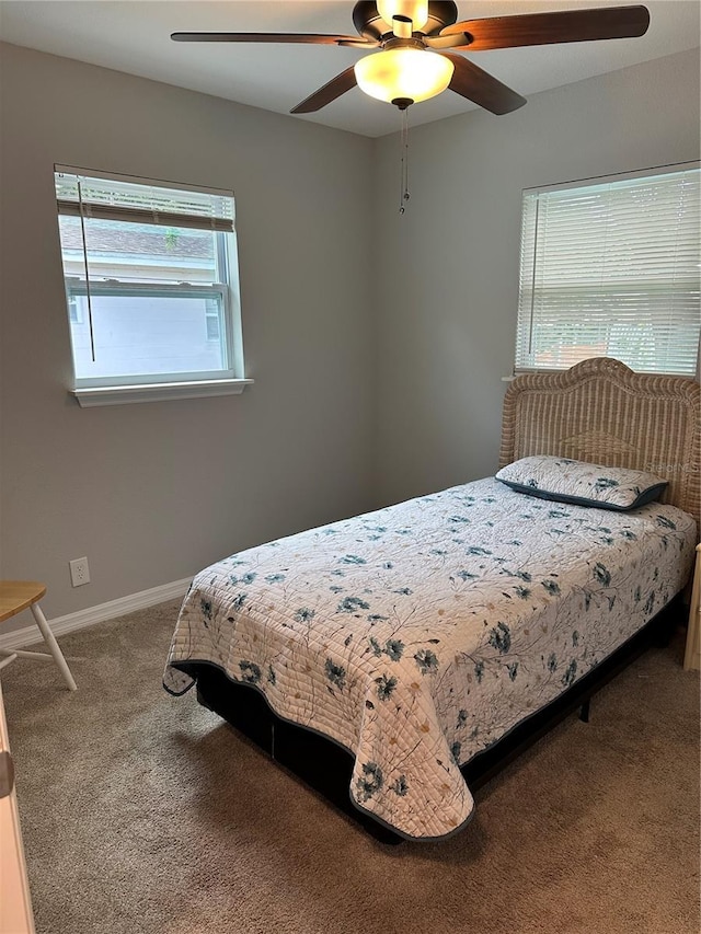 7651 46th Way N, Pinellas Park, FL 33781 - carpeted bedroom with baseboards and ceiling fan