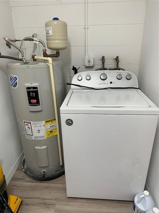 7651 46th Way N, Pinellas Park, FL 33781 - laundry room with washer / dryer, electric water heater, and light wood-type flooring