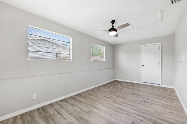 7891 67th St N, Pinellas Park, FL 33781 - empty room featuring a textured ceiling, wood finished floors, and a ceiling fan
