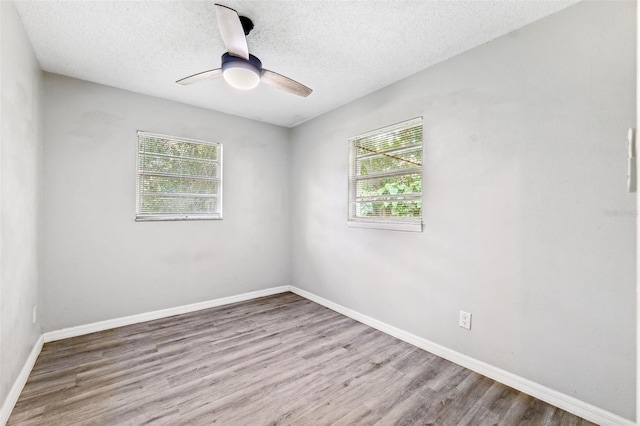 7891 67th St N, Pinellas Park, FL 33781 - spare room featuring plenty of natural light, wood finished floors, a textured ceiling, and ceiling fan