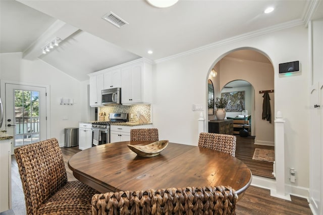 1208 E Crenshaw St, Tampa, FL 33604 - dining room with dark wood finished floors, arched walkways, and recessed lighting