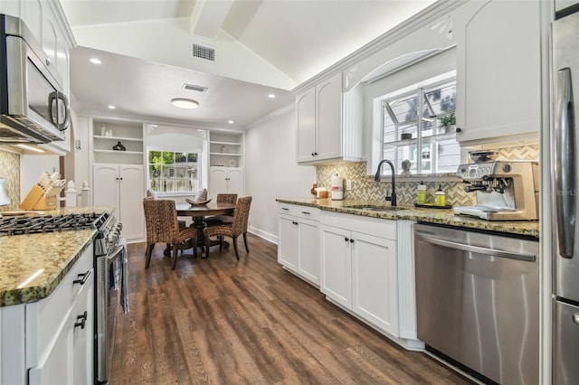 1208 E Crenshaw St, Tampa, FL 33604 - kitchen with stainless steel appliances, tasteful backsplash, dark wood finished floors, and white cabinetry