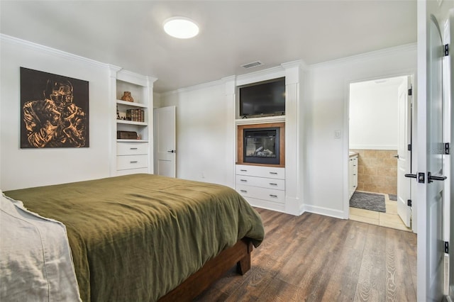 1208 E Crenshaw St, Tampa, FL 33604 - bedroom with wood finished floors and ornamental molding