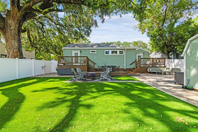 1208 E Crenshaw St, Tampa, FL 33604 - rear view of house with a deck, a patio area, and an outdoor fire pit