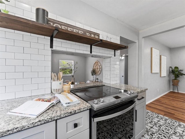 5514 7th Ave N, Saint Petersburg, FL 33710 - kitchen featuring electric range, open shelves, and light stone counters