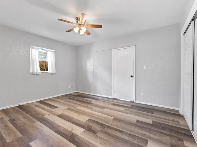 5514 7th Ave N, Saint Petersburg, FL 33710 - unfurnished bedroom featuring wood finished floors, a ceiling fan, a closet, and a textured wall