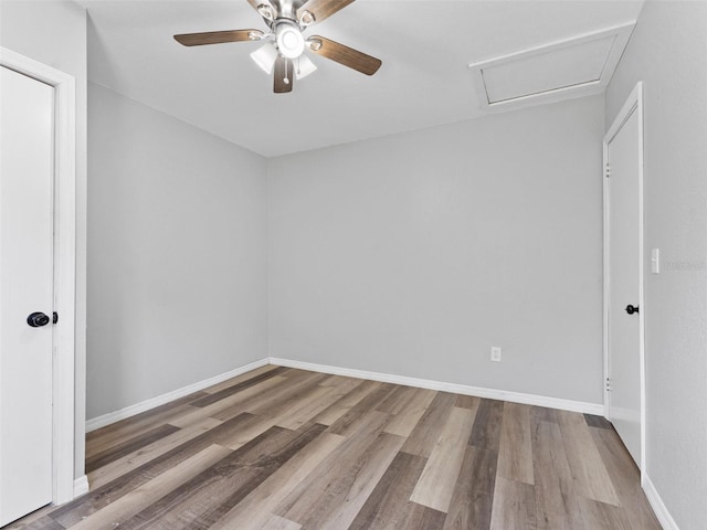 5514 7th Ave N, Saint Petersburg, FL 33710 - spare room featuring ceiling fan, wood finished floors, and attic access