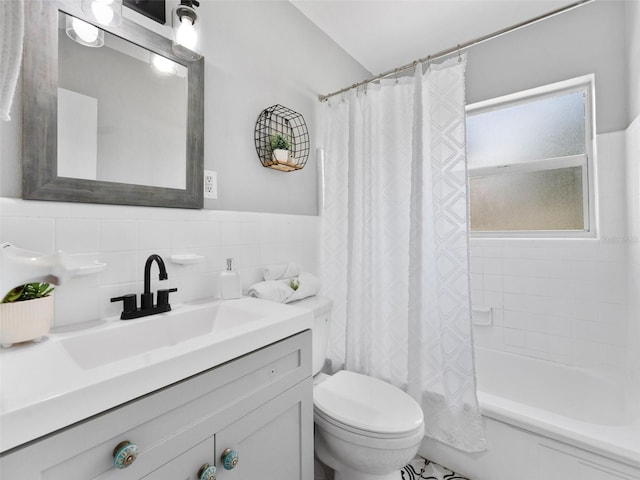 5514 7th Ave N, Saint Petersburg, FL 33710 - bathroom featuring vanity, tile walls, shower / bath combo with shower curtain, and wainscoting
