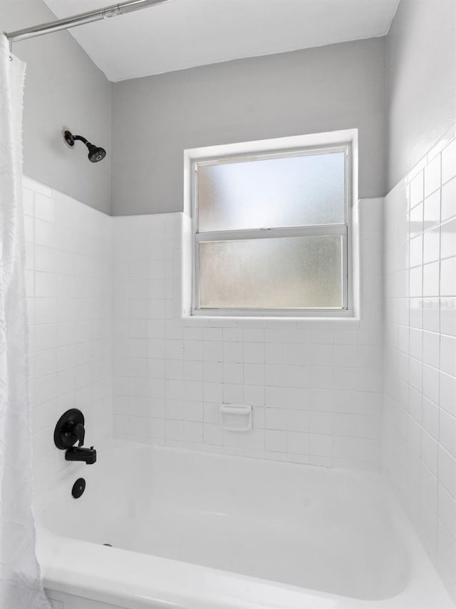 5514 7th Ave N, Saint Petersburg, FL 33710 - bathroom featuring shower / bath combo with shower curtain