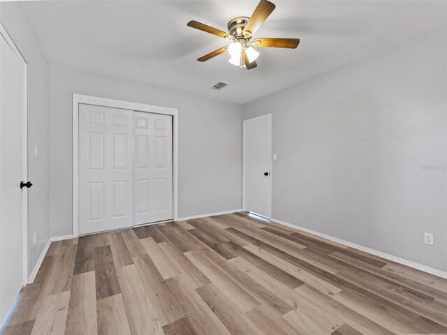 5514 7th Ave N, Saint Petersburg, FL 33710 - unfurnished bedroom featuring wood finished floors, a closet, and a ceiling fan
