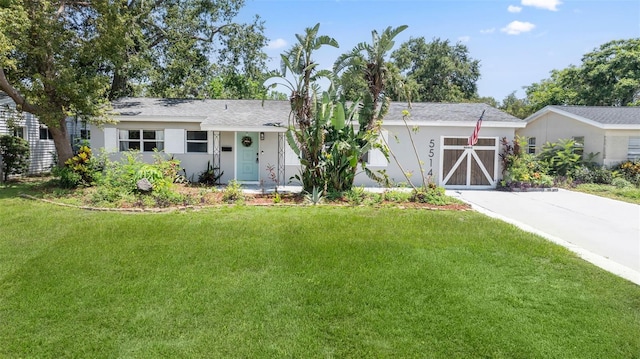 5514 7th Ave N, Saint Petersburg, FL 33710 - ranch-style house featuring a front lawn, concrete driveway, stucco siding, and an attached garage