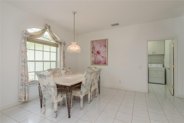 1156 Ridgegrove Dr W, Palm Harbor, FL 34683 - dining space with washer / dryer, a chandelier, healthy amount of natural light, and light tile patterned floors