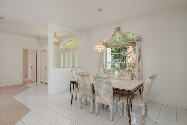 1156 Ridgegrove Dr W, Palm Harbor, FL 34683 - tiled dining area with a chandelier and baseboards