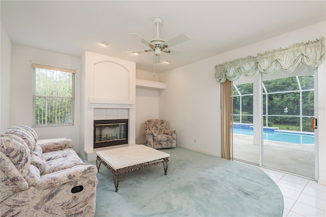 1156 Ridgegrove Dr W, Palm Harbor, FL 34683 - living area featuring ceiling fan, a fireplace, and light colored carpet