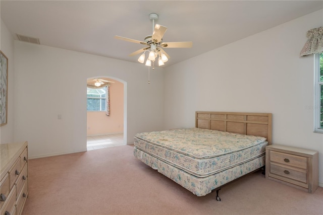 1156 Ridgegrove Dr W, Palm Harbor, FL 34683 - bedroom featuring light carpet, ceiling fan, and arched walkways