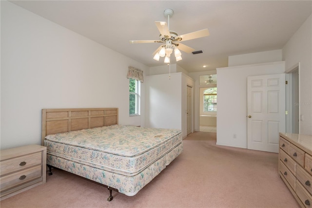1156 Ridgegrove Dr W, Palm Harbor, FL 34683 - bedroom featuring light colored carpet, a ceiling fan, and ensuite bath